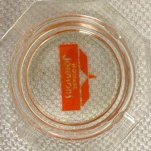 Vintage Howard Johnson clear glass ashtray with orange logo.